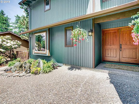 Front door with bubbling fountain and greenery.