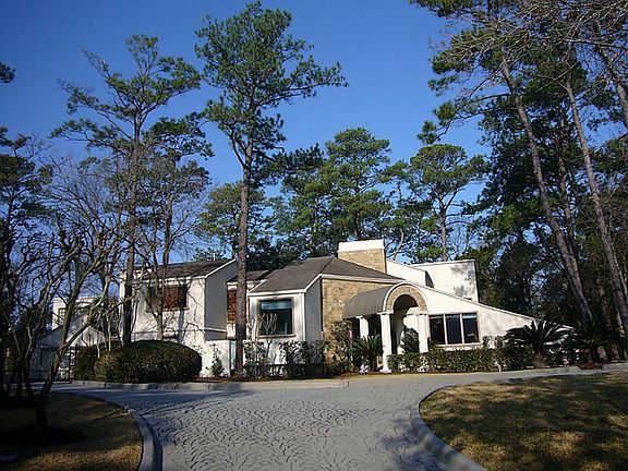 Front elevation of this 6,338 SF house on 0.8 acre wooded lot in desirable Piney Point Village