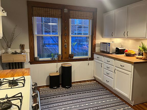 Great size renovated kitchen with hardwood countertops, plenty of cabinets, gas stove, and hardwood floors.