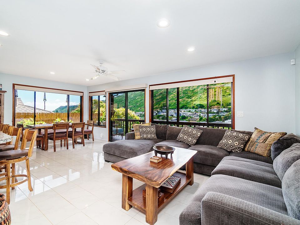 spacious living room open floor plan from kitchen and dining area opens to back lanai and views; comfortable large couch