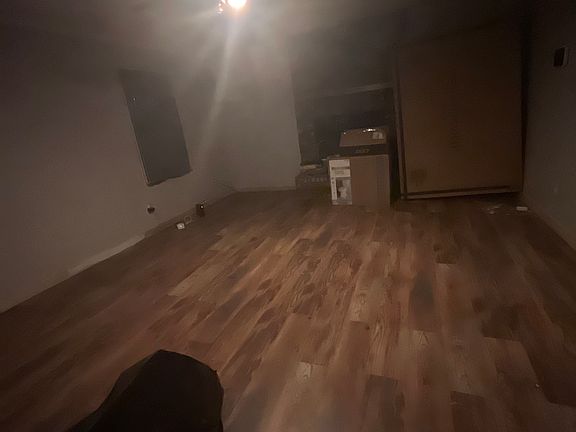 The spacious living room features hardwood floors and a cozy fireplace, perfect for cozy for chilly nights. Adding to the room's functionality is a spacious glass closet, providing ample storage while, combining style with practicality.