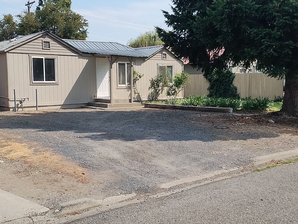 This photo displays the garage located in the rear of the property, as well as the spacious driveway.