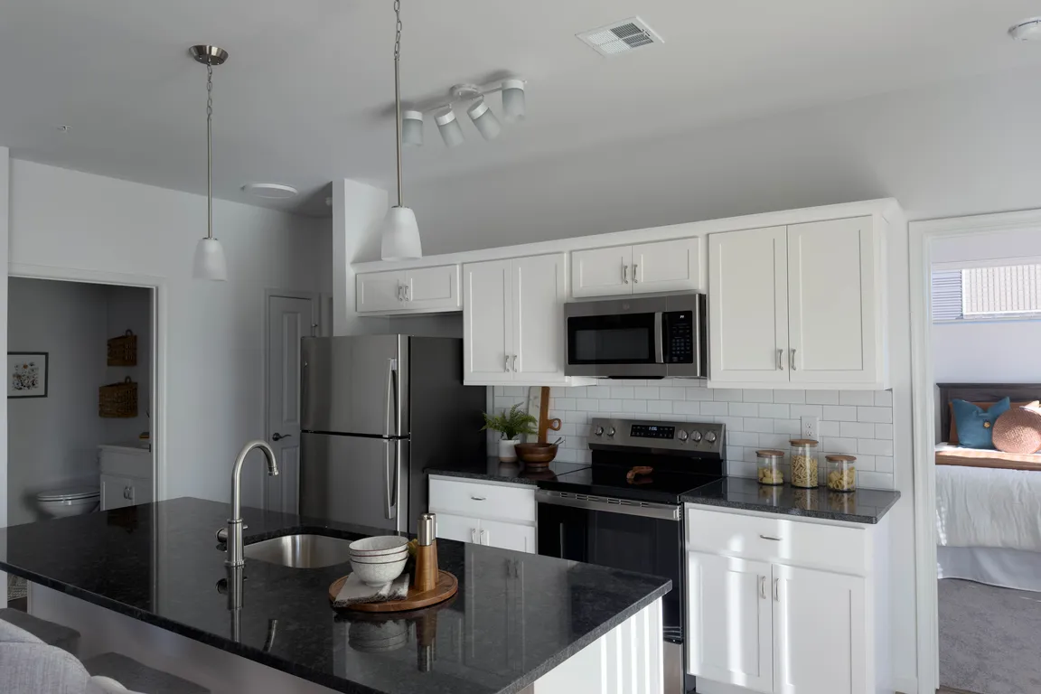 The modern kitchens at Briar Ridge Commons feature stainless steel appliances, granite countertops, and island sink and breakfast bar.
