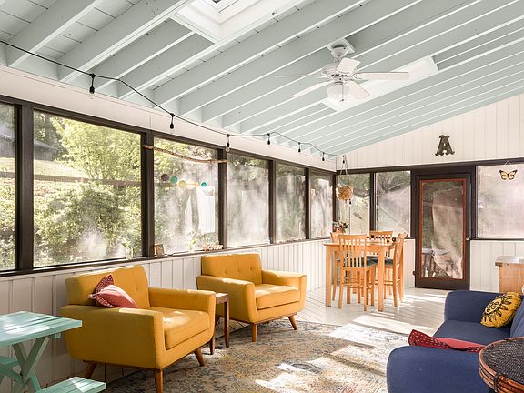 Dreamy, enclosed back porch perfect for dining, extra living space and hosting.