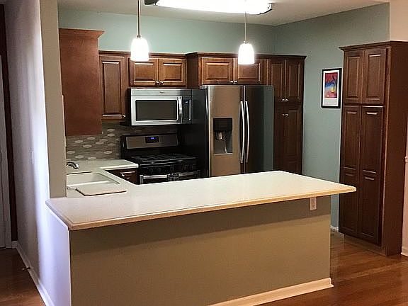 Kitchen with eat on bar. 