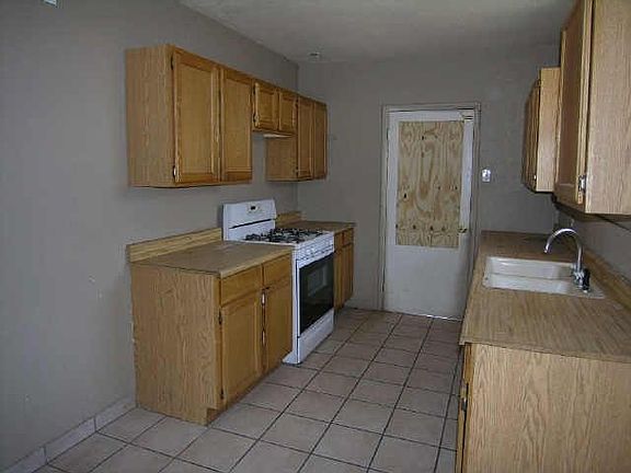 Front house kitchen has newer cabinets and sink