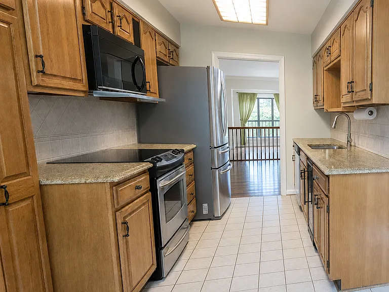 Updated kitchen with granite countertops and stainless steel appliances.