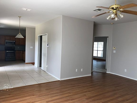 Large family room. On the left showing breakfast nook and kitchen. To the right the main entrance, stairway and formal living area.