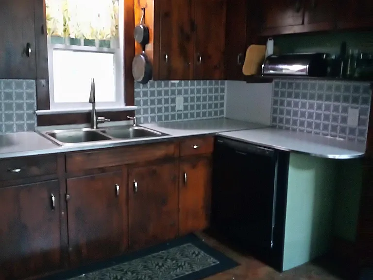 Country kitchen open to dining and living room. Dishwasher, new sink, large refrigerator