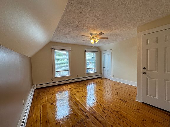 Front Entrance - Living room w new ceiling light/fan - wide pine flooring and coat closet