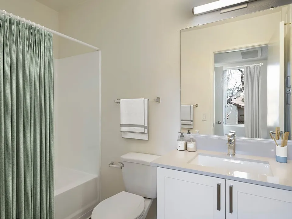 Renovated Package I bath with light grey quartz countertops and new white cabinetry