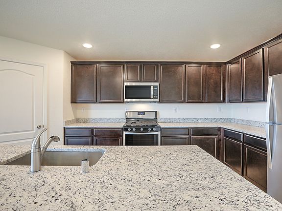 Upgraded kitchen with stainless appliances, granite countertops, recessed lighting, and more.