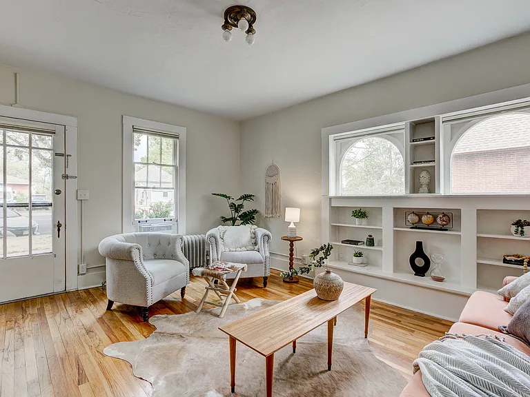living room with north facing arched windows and original built-in bookshelves