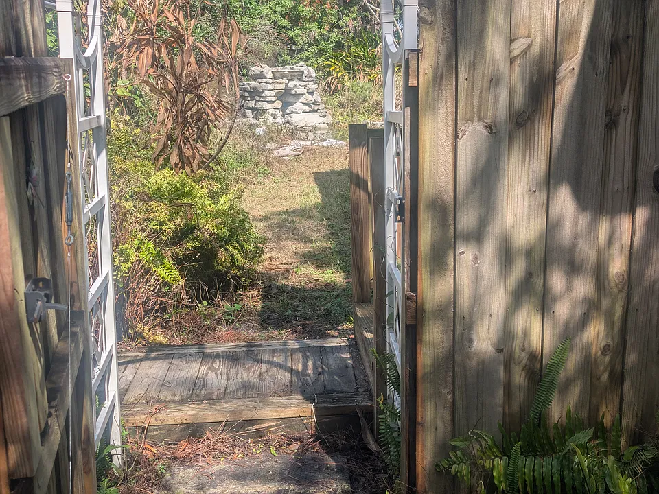 4 - Gate access view of the waterfall and pond. To the left is the patio and to the right is the entrance to the suite.