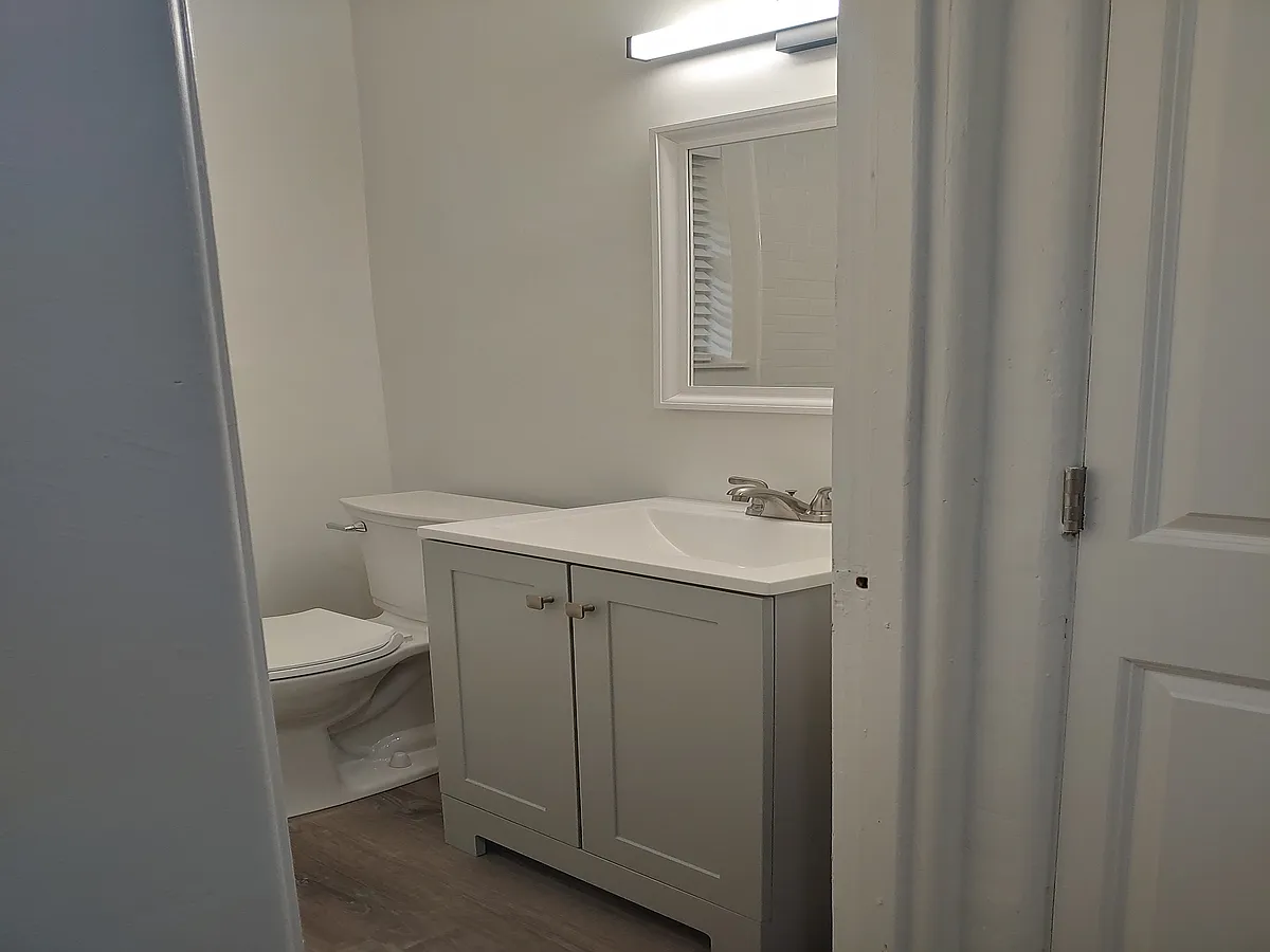 Bathroom with sleek vanity - Highland Corners Apartments