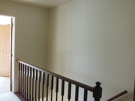 hallway upstairs with additional crawlspace storage above