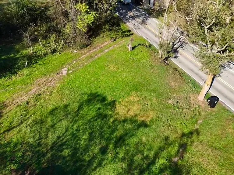 Bird eyes view of large yard and on land Parking and street