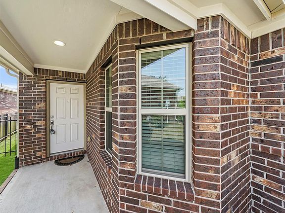The covered porch leading to the front entry offers plenty of space for a bench or chairs. What a lovely spot to sit and enjoy the great neighborhood.