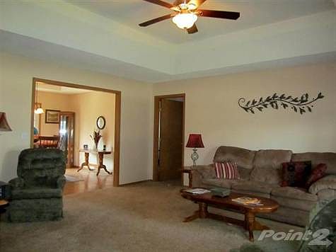 Large living room with a door leading to 2 bedrooms and a bathroom.