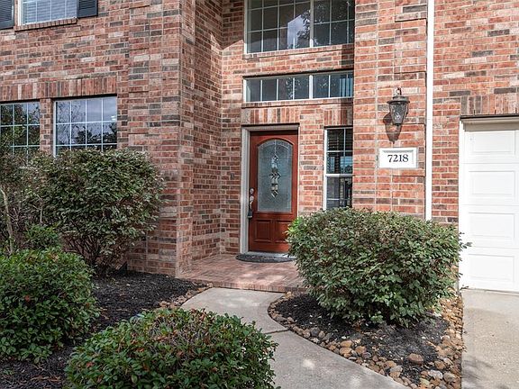 A close-up of this welcoming all brick 2-story entry and lush landscape! This home is conveniently located in walking distance to Benignus Elementary and only blocks from community lake, pool and walking trails!