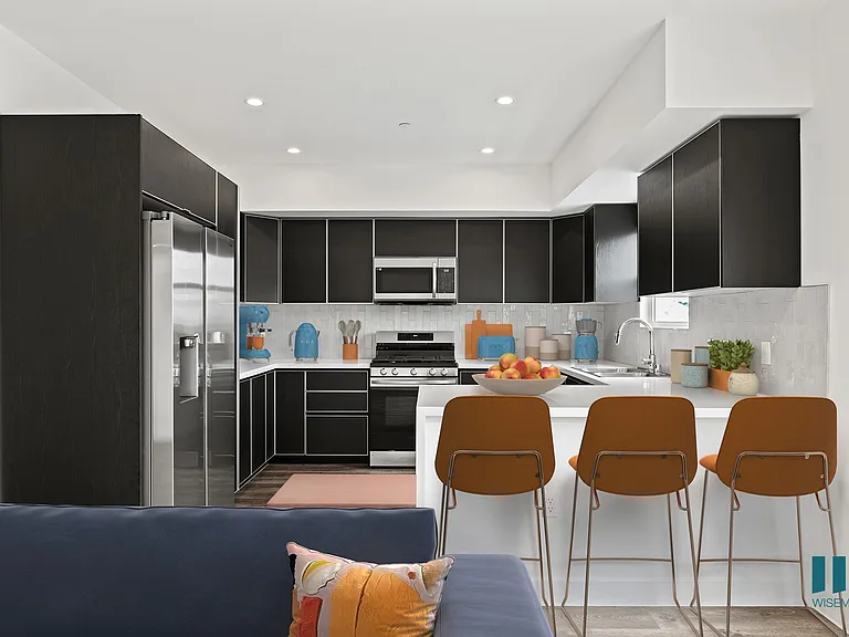 Large-Size Kitchen with Countertop-Bar, Stainless-Steel Appliances, and Ample Cabinet Storage