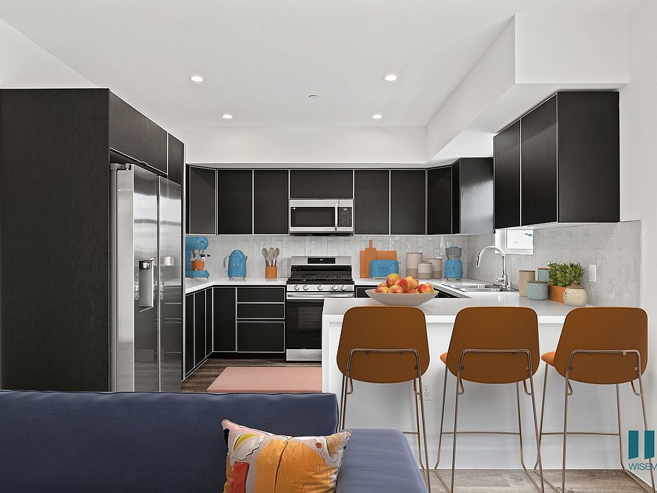 Large-Size Kitchen with Countertop-Bar, Stainless-Steel Appliances, and Ample Cabinet Storage