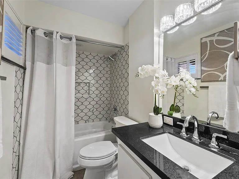 Newly renovated bathroom with full-size tub and shower.