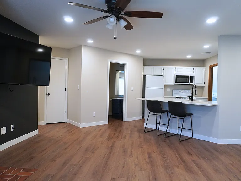 Spacious living room with easy access to the outdoor screened-in porch on the first level_perfect for relaxation! Please note, the TV is not included.