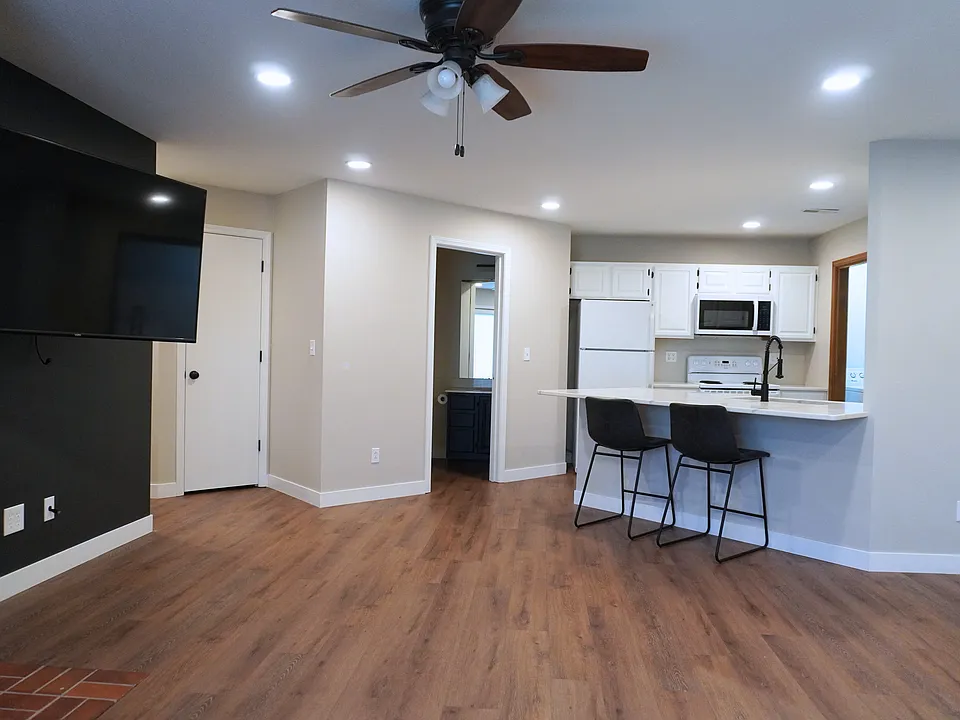 Spacious living room with easy access to the outdoor screened-in porch on the first level_perfect for relaxation! Please note, the TV is not included.