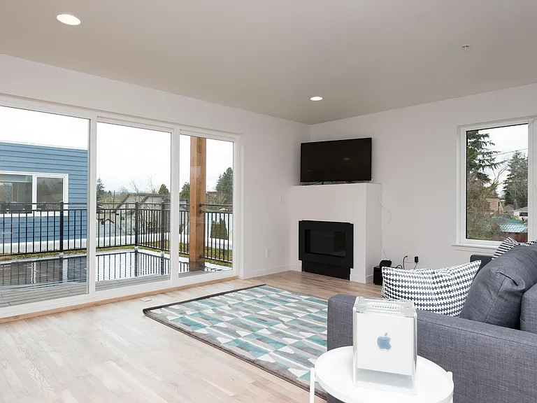 Fourth floor Family Room (or 5th Bedroom) with fireplace, balcony and wet-bar