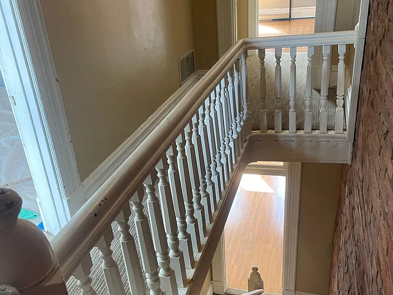 top of steps on floor with two bedrooms, 1/2 bath and laundry