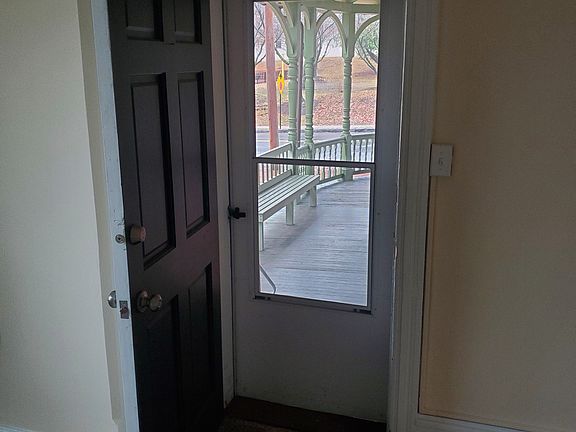Entrance from side porch into the larger bedroom. Faces the front of the house.