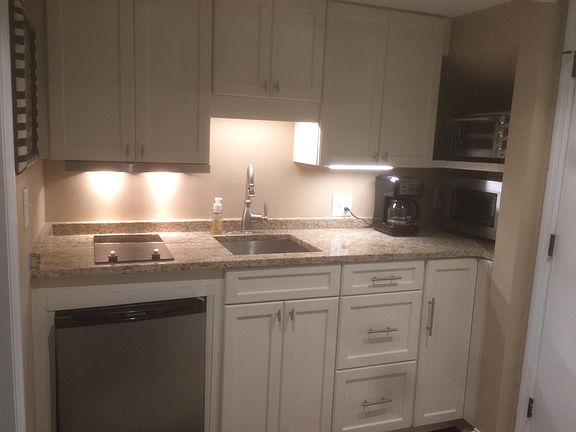 Undercounter lighting in completely furnished kitchenette.