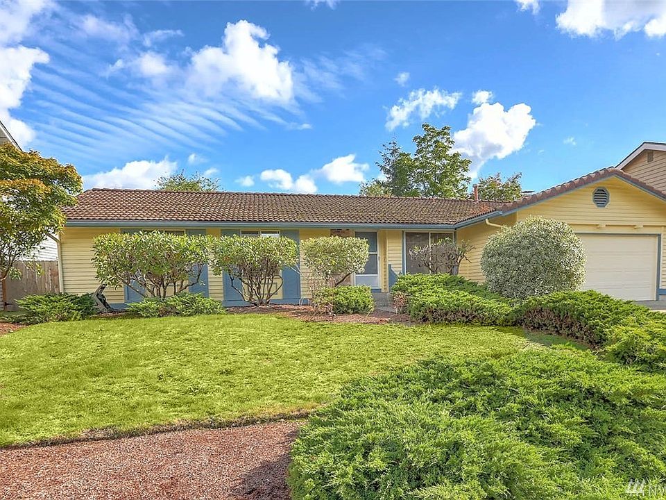 Welcome home to desirable Fairwood Greens! This 3 bedroom, 2 bathroom rambler has tons of potential to shine! The bones are all there; cedar siding, a tile roof that lasts a lifetime, lots of large windows that provide tons of natural light and a large, terraced back yard with an entertainment size deck. You will want to take note of the vaulted ceiling and cozy fireplace in the family room with open sight-lines and easy flow for entertaining. Delight in the wonderful layout of this home, the master with ensuite bath, 2 additional guest rooms....and let's not forget wonderful curb appeal.