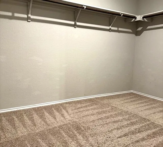 Spacious walk-in closet in primary bedroom and bathroom.