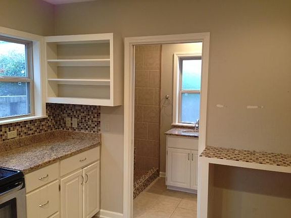 Kitchen looking into bathroom