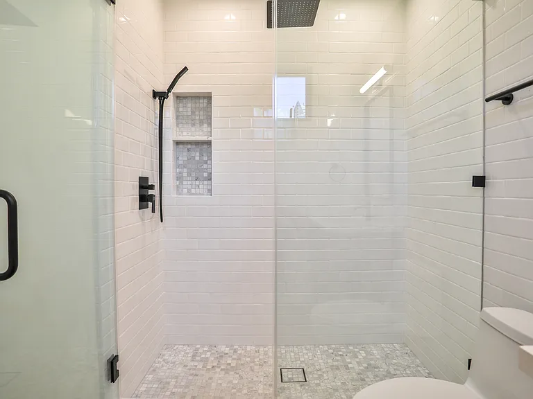 Large shower with rainfall shower head and hand-held shower