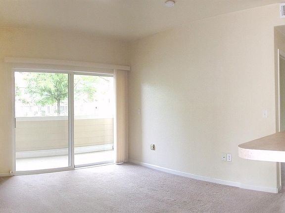 Livingroom with Gas Fireplace, Sliders to Covered Patio.  Filled with Natural Light.