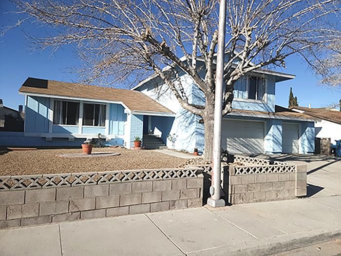 Large Shade tree in front and large driveway of 3 car garage