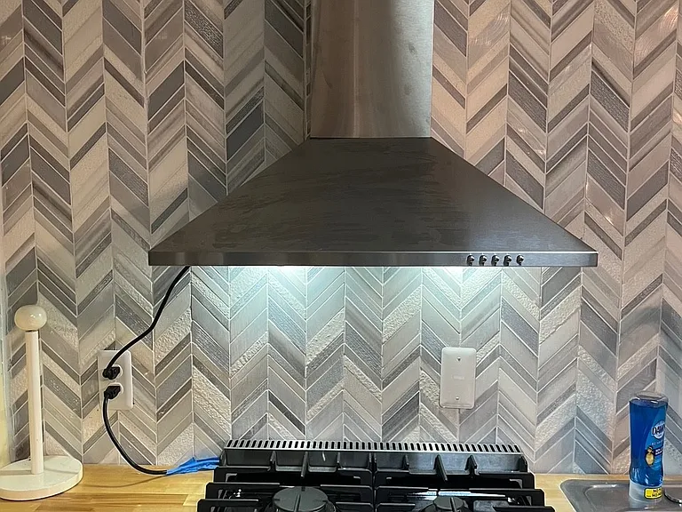Gas stove with euro style vent hood.
