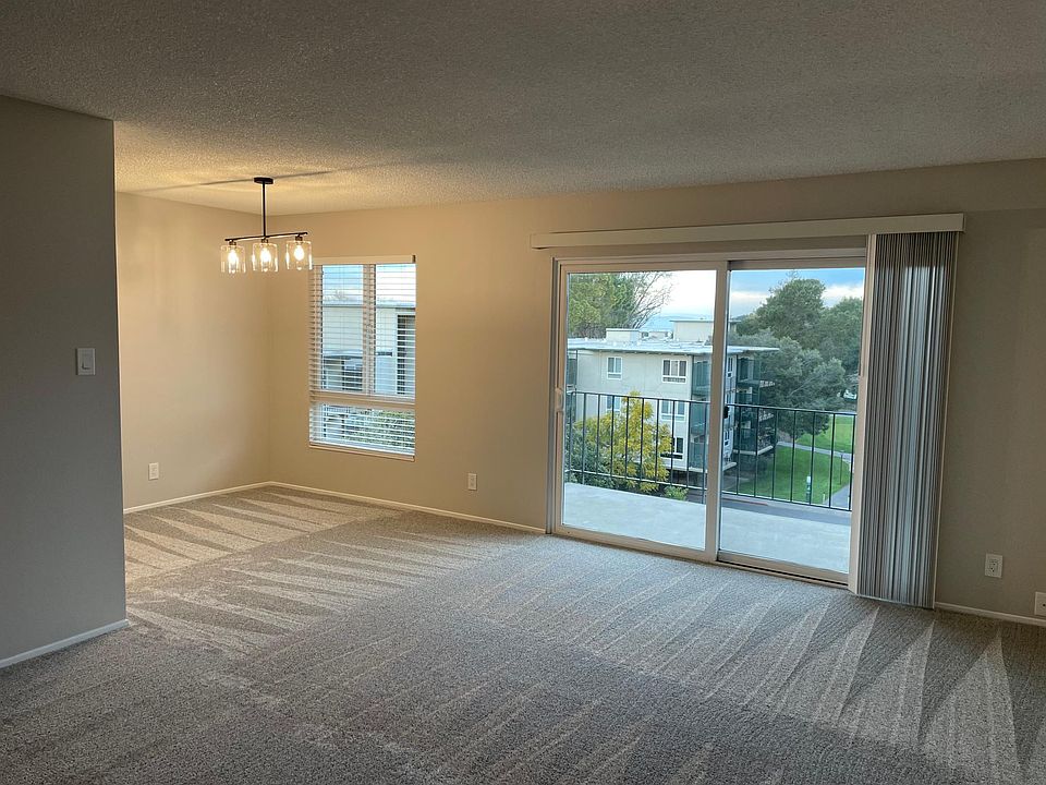 Open concept dining and living room. Large slider gives you great views of the manicured common areas and glimpses of the bay.