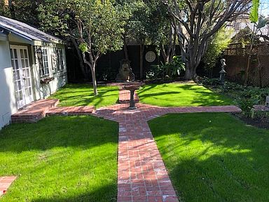 Backyard with fountain and showing guest house/studio. Nearly private.