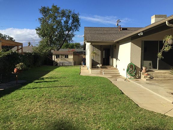 Spacious grass front yard. Playhouse in rear has been removed