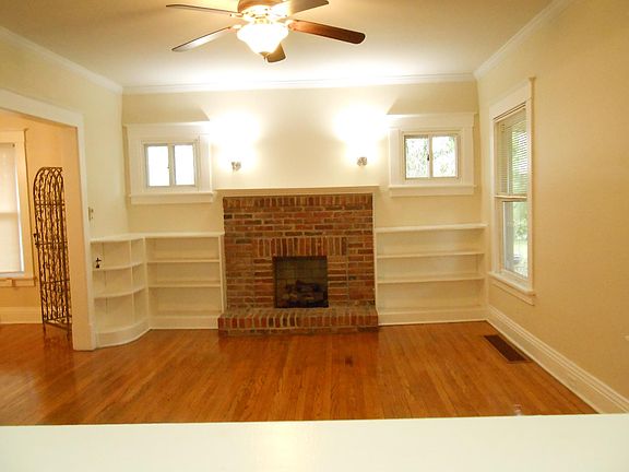 LIVINGROOM WITH BUILT IN SHELVING AND FIREPLACE