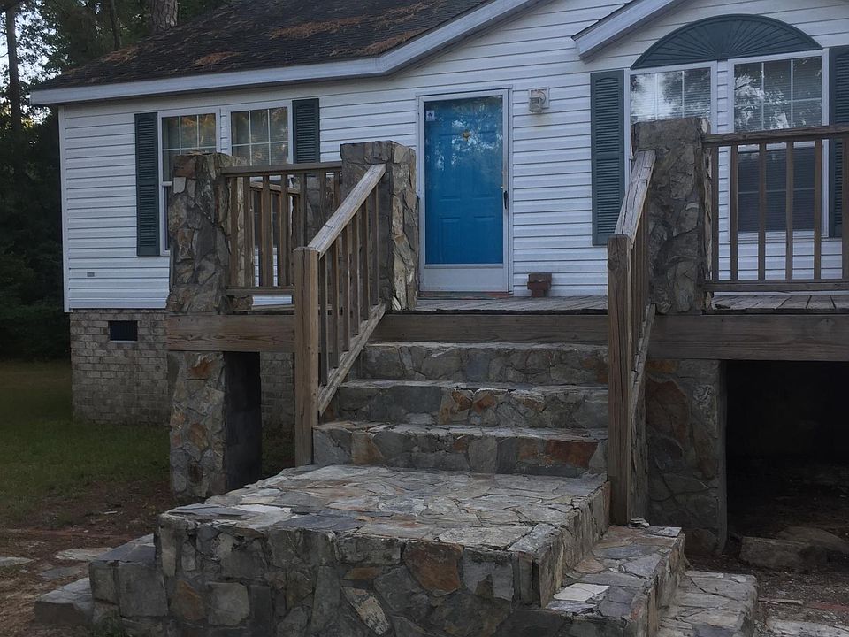 Stone and wood uncovered front porch.