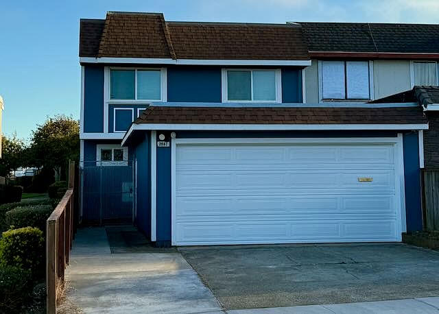 Front of the house with 2-car garage + driveway