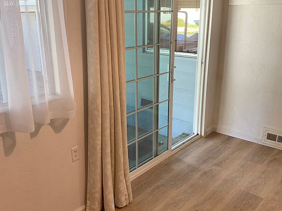 Entrance from the carport with new luxury vinyl flooring.