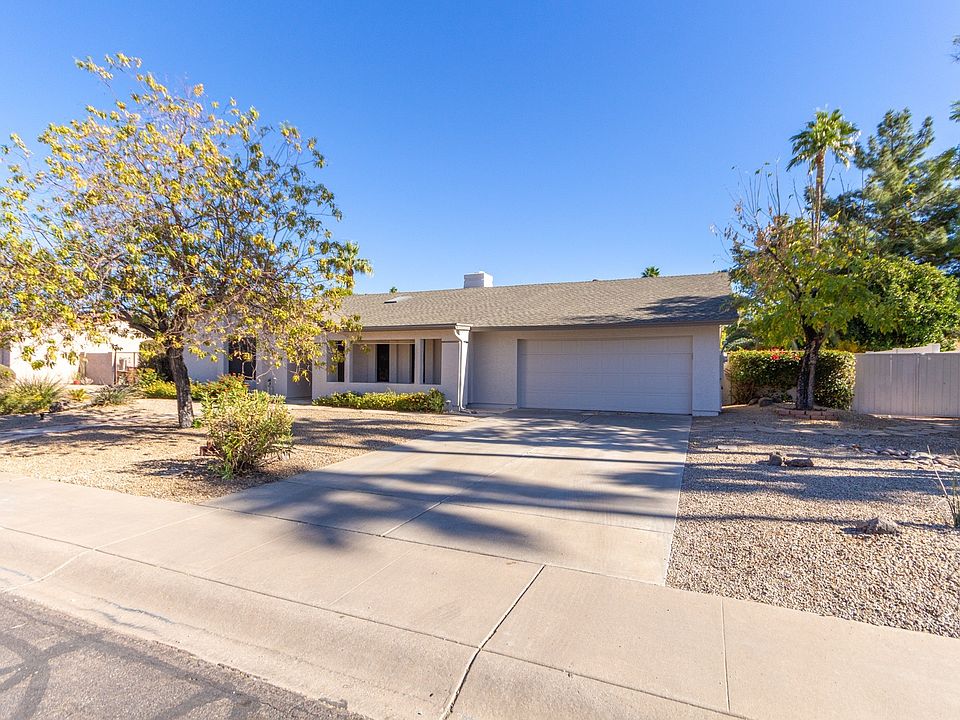Front Exterior
Crisp front elevation featuring low-maintenance desert landscaping and a wide driveway for easy access.