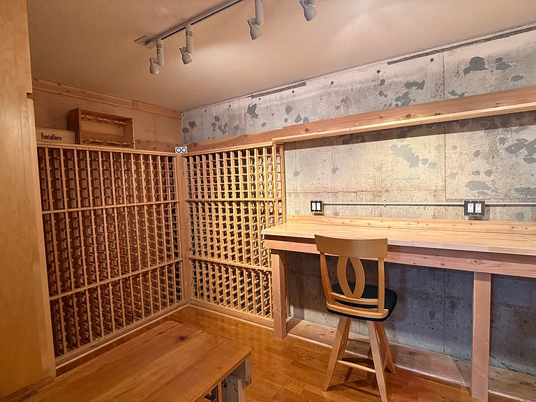 A dedicated corner of the arts and crafts studio is reserved for stylish and practical wine storage.