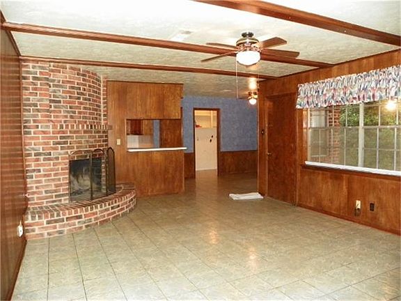 Unique round corner fireplace is a focal point.